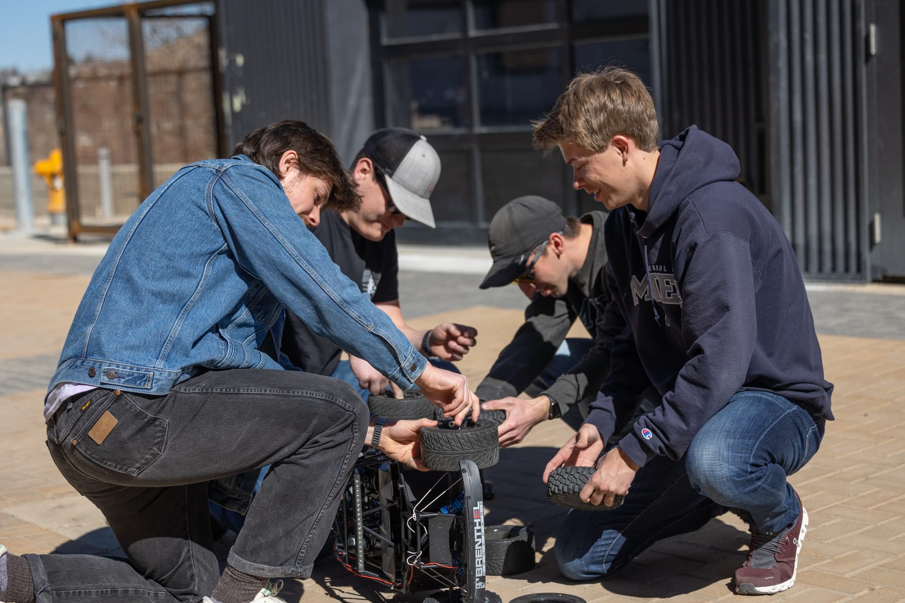 Students assembling an RC car at a hands-on workshop